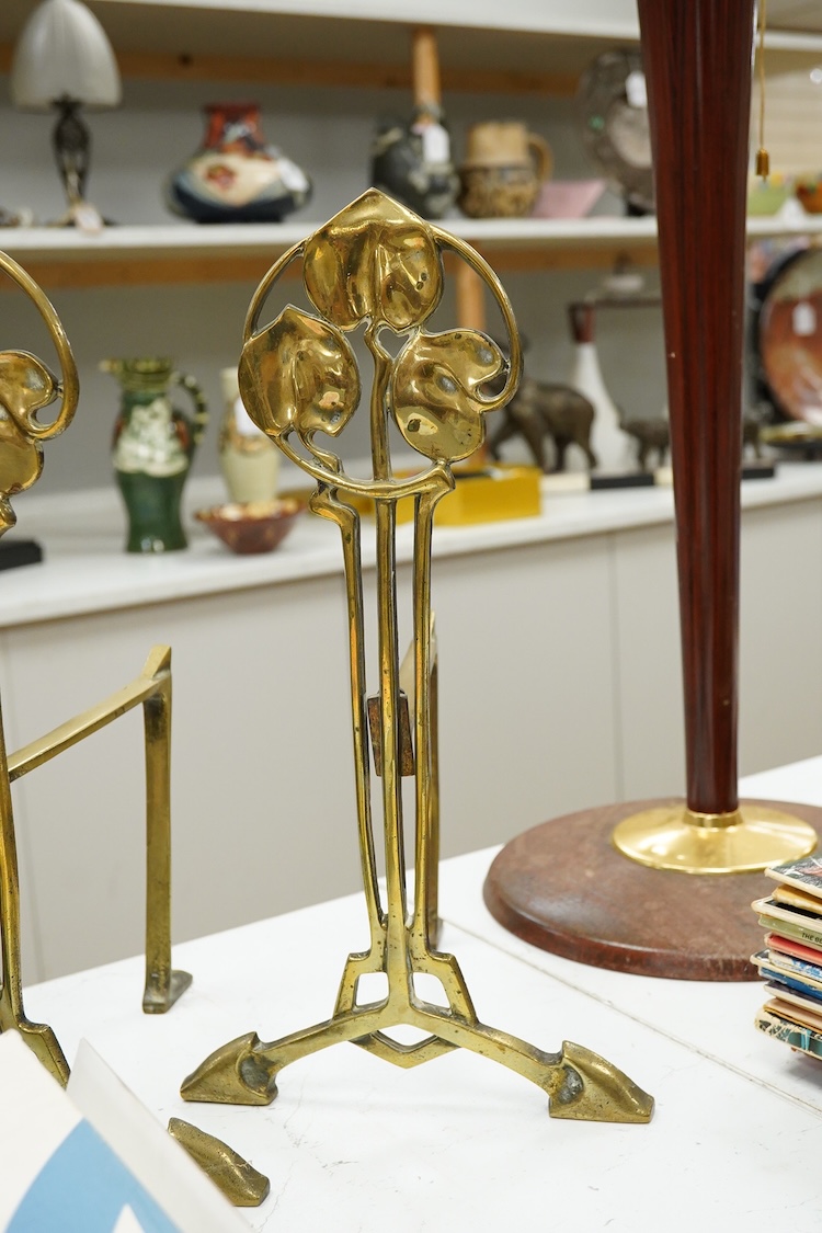 A pair of Art Nouveau brass firedogs, 35cm high